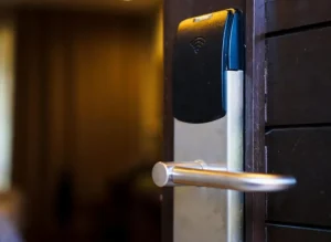 RFID hotel door lock reader beside a guest-room door